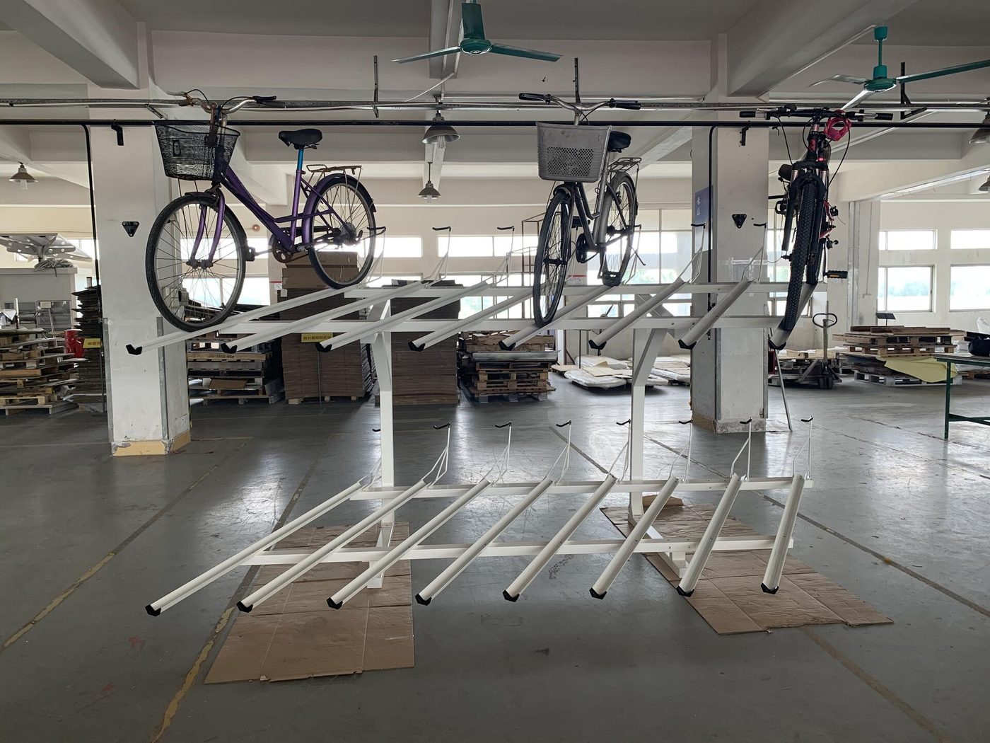 Powder-coated steel racks on the factory floor